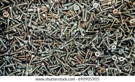 tapping screws made od steel, metal screw, iron screw, chrome screw, screws as a background, wood screw, Royalty-Free Stock Photo #690905905