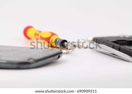 Cell phone repair. Smartphone parts and tools for recovery, selective focus.