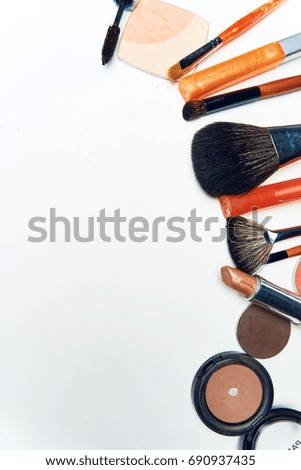 Powder, shadows, lipsticks, highlighter, cosmetics for makeup on a hot background                               