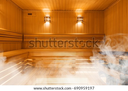 Interior of Finnish sauna, classic wooden sauna Royalty-Free Stock Photo #690959197