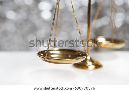 Close up of gold brass balance scale, Sign of justice isolated on bokeh background