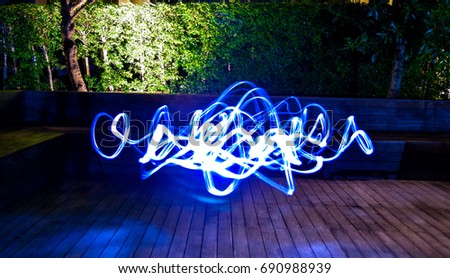 Modern abstract of light motion on the wooden. Nature in the background.