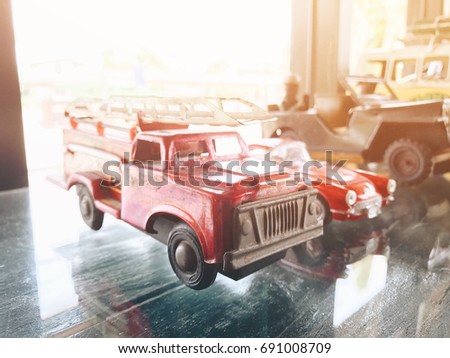 Car toy in many color with close up shot with copy space.Light flare abstract texture background.