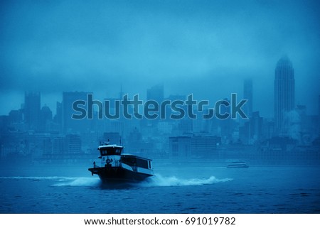 Midtown Manhattan skyscrapers and boat in fog in New York City