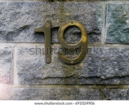 House number on the wall nineteen (19)