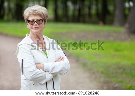 Portrait of senior coach and trainer woman standing with crossed arms at training, copyspace