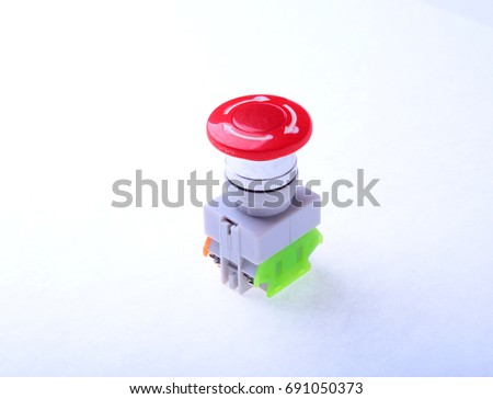 Close-up emergency stop button isolated on white background.