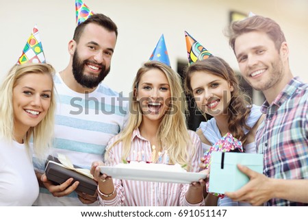 Group of friends having fun at birthday party