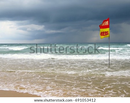 "Swim here" flag on a beach in Phuket, Thailand