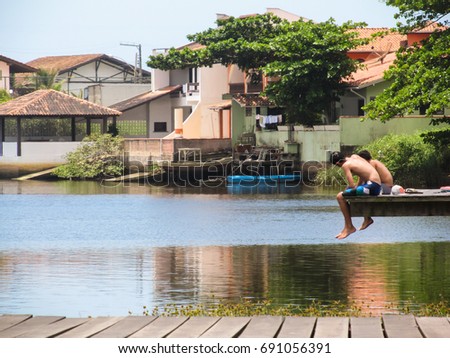 Summertime vibes - two boys relaxing by the river (Barra Velha, Brazil)