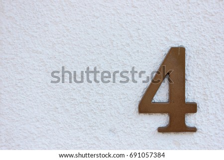 House number on white wall four