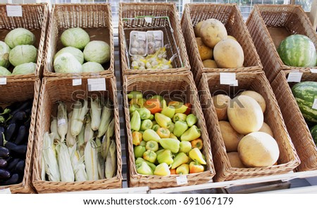 Vegetables stacked in baskets on the store counter with price tags