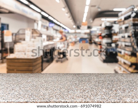 Marble board empty table in front of blurred background. Perspective table over blur in supermarket - can be used for display or montage your products. Mockup for display of product.