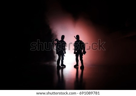 Anti-riot police give signal to be ready. Government power concept. Police in action. Smoke on a dark background with lights. Blue red flashing sirens. Dictatorship power. Selective focus