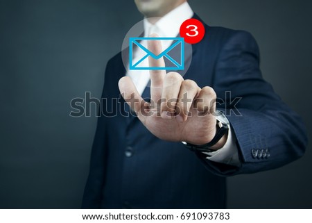 Businessman touching email icon on a virtual screen