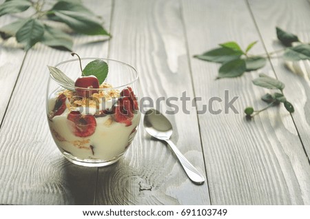 Yogurt with granola and cherries in glass. Healthy food, Diet, Detox, Clean Eating, Vegetarian concept. Toning