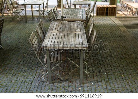 Wooden chairs and table in cafeteria.