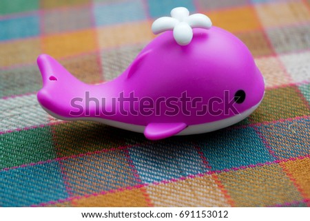 Dolphin mini toy for child. Dolphins are a widely distributed and diverse group of aquatic mammals. Concept photo for save dolphin.