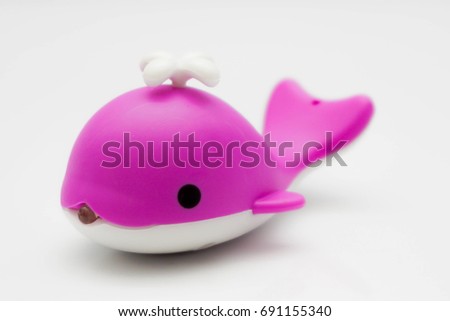 Dolphin mini toy for child isolated on white background. Dolphins are a widely distributed and diverse group of aquatic mammals. Concept photo for save dolphin.