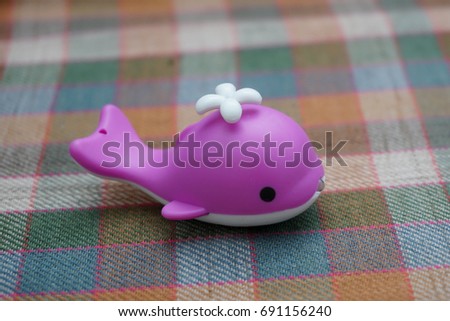 Dolphin mini toy for child. Dolphins are a widely distributed and diverse group of aquatic mammals. Concept photo for save dolphin.
