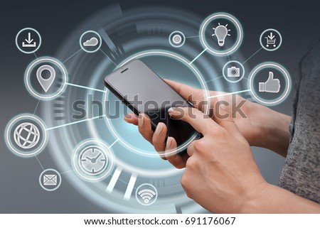 Close up of female hands with generic design smartphone and various apps infographics. Copy space for your text.