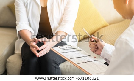 Doctor (obstetrician, gynecologist or psychiatrist) consulting and diagnostic examining woman patient's obstetric - gynecological health in medical clinic or hospital healthcare service center Royalty-Free Stock Photo #691186021