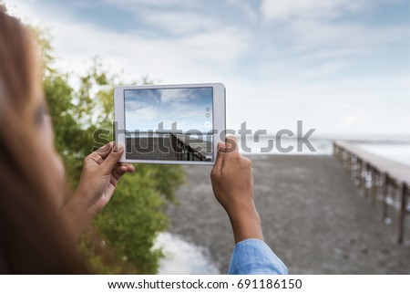 woman use digital tablet taking landscape photo