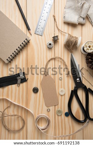 Price tag or Label with tailor supplies on wooden table.