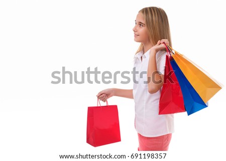 shopping, sale, christmas and holiday-pretty teenage girl with shopping bags in profile , isolated over white background with copyspace