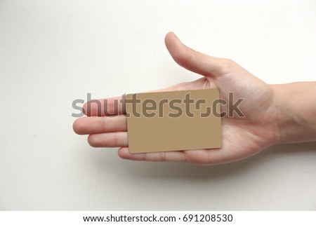 Bank concept. A female hand holds a plastic gold card. Photo for your design