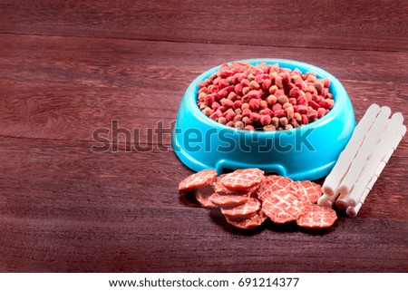 Dog snack ,dog dood, dog chews, dog biscuits on a grey wooden table wall background with copy space .