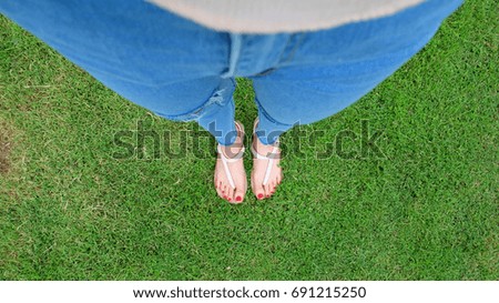 Feet Selfie in Gold Sandals Standing on Green Grass Background Great For Any Use.
