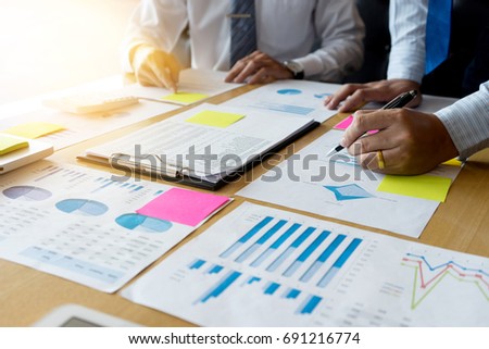 Two businessman working  with graph chart for marketing plan