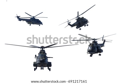 Photo of four military helicopters flying together while doing demonstrations, isolated on white background Royalty-Free Stock Photo #691217161