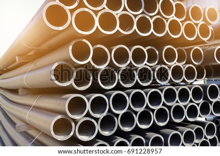 Plastic pipes in stock of finished products stacked in packs Royalty-Free Stock Photo #691228957
