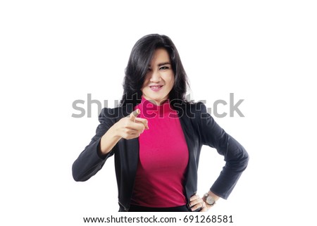 Photo of a beautiful female entrepreneur looks angry while pointing at the camera, isolated on white background