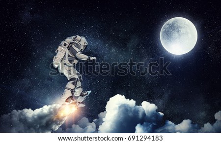 Astronaut surfing dark sky. Mixed media Royalty-Free Stock Photo #691294183