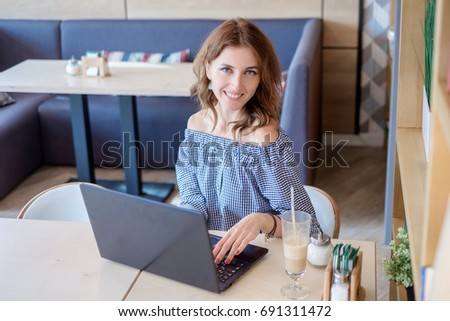 Businesswoman Working On Laptop In Coffee Shop. Young business woman uses laptop in cafe. Businesswoman working typing in a laptop. Business infographic