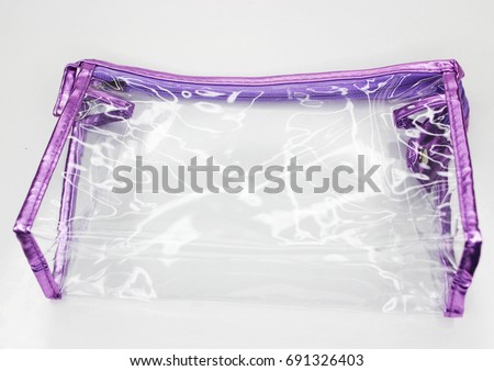 Transparent silicone bag for cosmetics on a white background. Royalty-Free Stock Photo #691326403