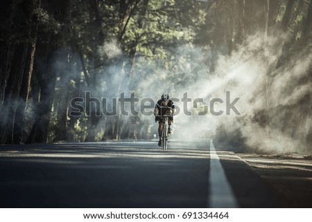 Asian men are cycling road bike in the morning Royalty-Free Stock Photo #691334464