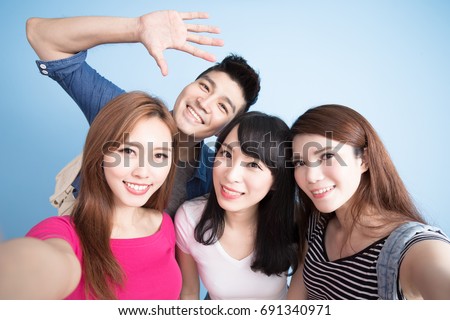 student selfie happily on the blue background