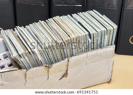Many labor books in the old box on the background of business folders. HR Management
