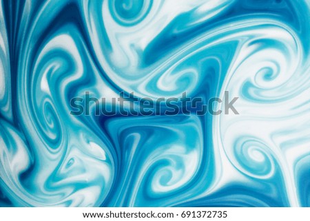 Swirl shape made with blue and white paint.