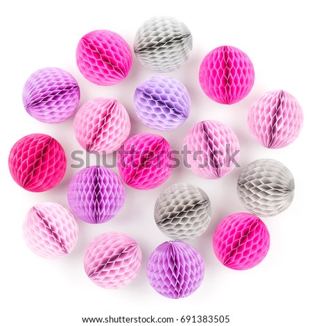 Honeycomb balls decorations background.  Pink, lilac and gray paper pom pom. Flat lay.  Holiday concept