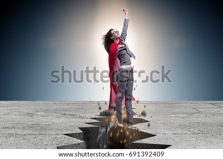 Superhero businesswoman escaping from difficult situation Royalty-Free Stock Photo #691392409