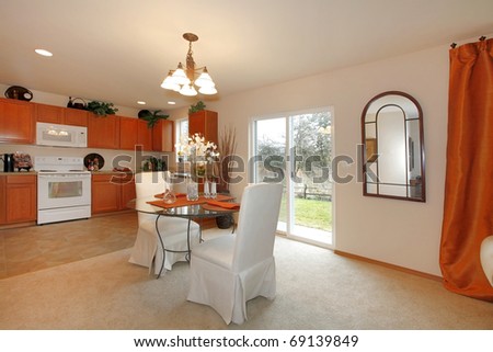 Living room and dining room with beige and orange.