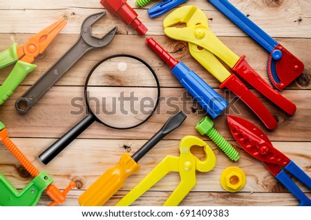 magnifying glass and instruments toys on wood texture creativity ideas concept with copy space for your text