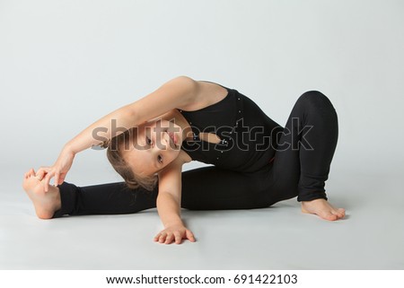 Beautiful girl doing yoga on a white background