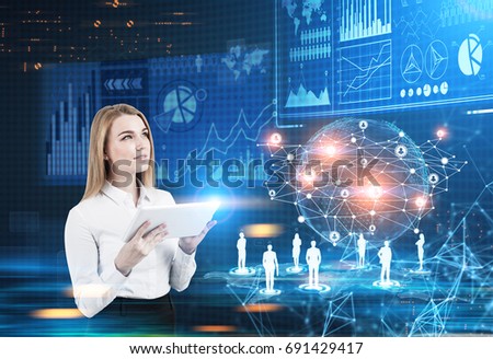 Inspired blonde businesswoman with a tablet is looking at an Earth hologram and infographics in a futuristic surrounding. Toned image double exposure. Elements of this image furnished by NASA