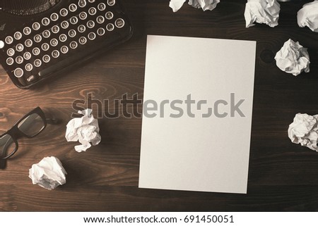 High angle view of blank paper sheet on a wooden desk with copy space